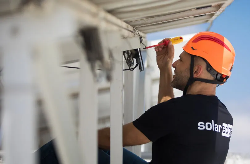 A man installing solar equipments.